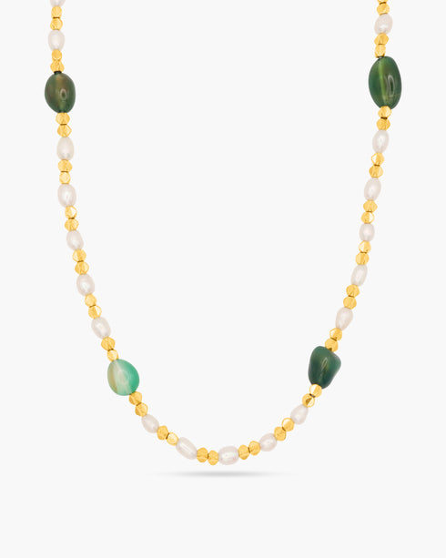 Necklace with green and gold beads on a white background